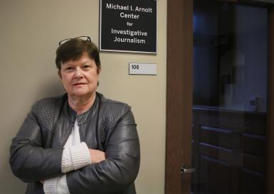 Kathleen Johnston standing outside the Michael I. Arnolt Center for Investigative Journalism