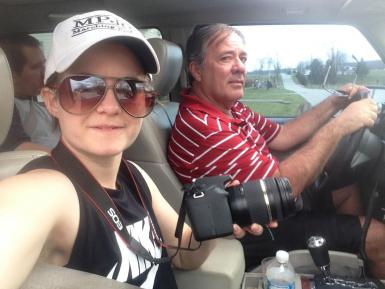 M.S. student Layn Pieratt rides in a car with her father, Marty Pieratt. Layn is holding a camera.