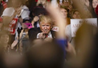 Donlad Trump pointing at an audience member at a rally