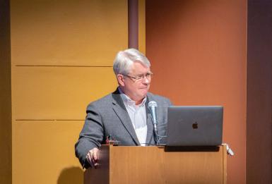 John Hamilton speakes at a podium.