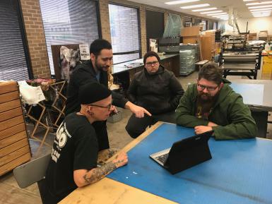 (Left to right) Texas Tech associate art professor Stacy Elko, IU Media School assistant professor John Velez and two graduate students review an early version of the app.