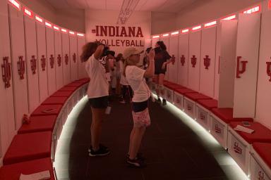 Girls take photos in the IU volleyball locker room.