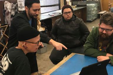 (Left to right) Texas Tech associate art professor Stacy Elko, IU Media School assistant professor John Velez and two graduate students review an early version of the app.