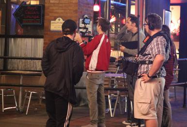 A camera crew films outside the Buskirk-Chumley Theater.