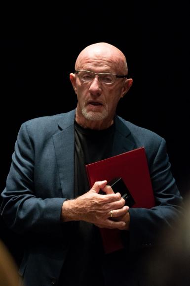 Jonathan Banks holding a binder and a box that contains the Bicentennial Medal