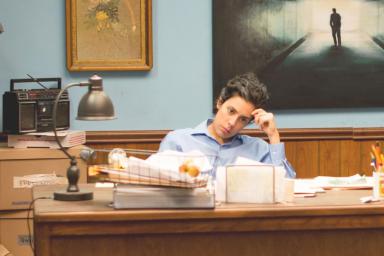 A woman sits at a desk