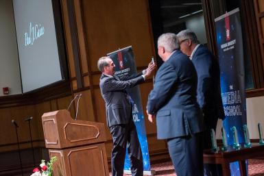 Paul Caine takes a selfie on stage