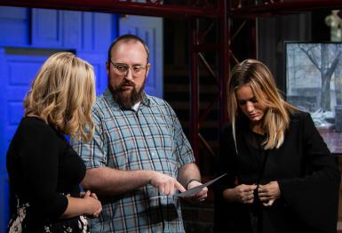 Karli VanCleave, Dan Brown and Katrina Nickell look at a piece of paper