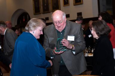 Bob Hammel examines Tracy Dodds' trophy