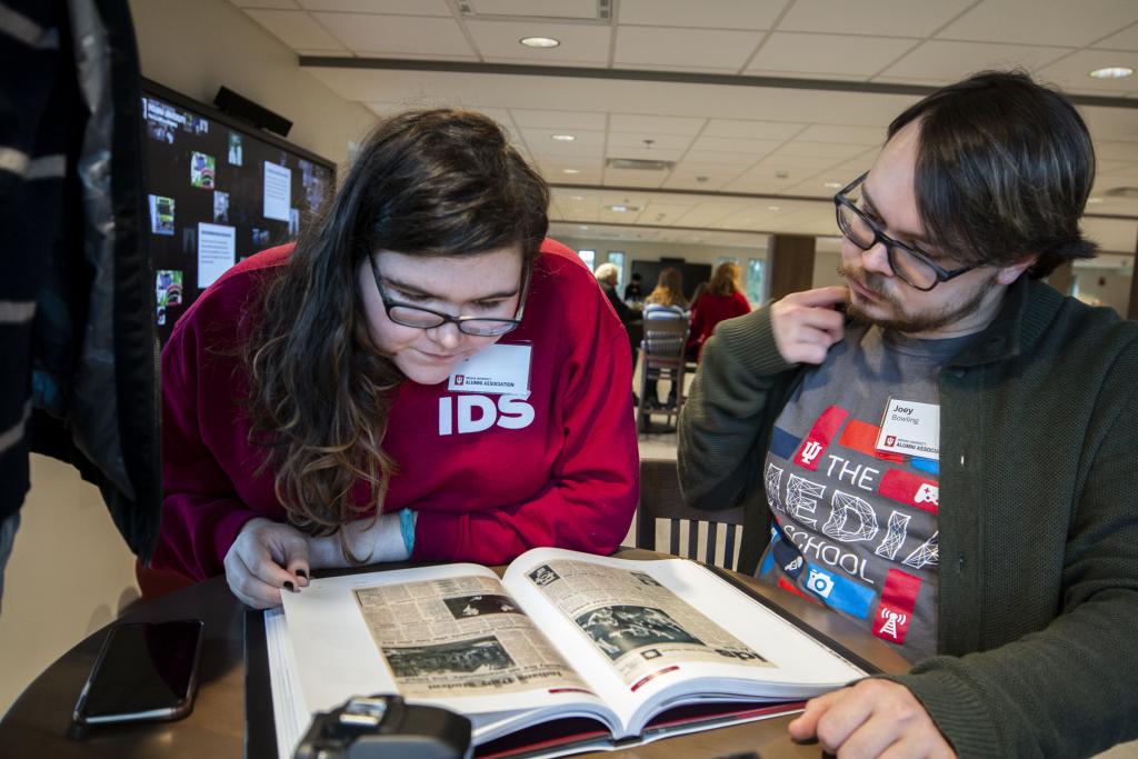 Ellen Hine and Joey Bowling read "Indiana Daily Student: 150 Years of Headlines, Deadines and Bylines"