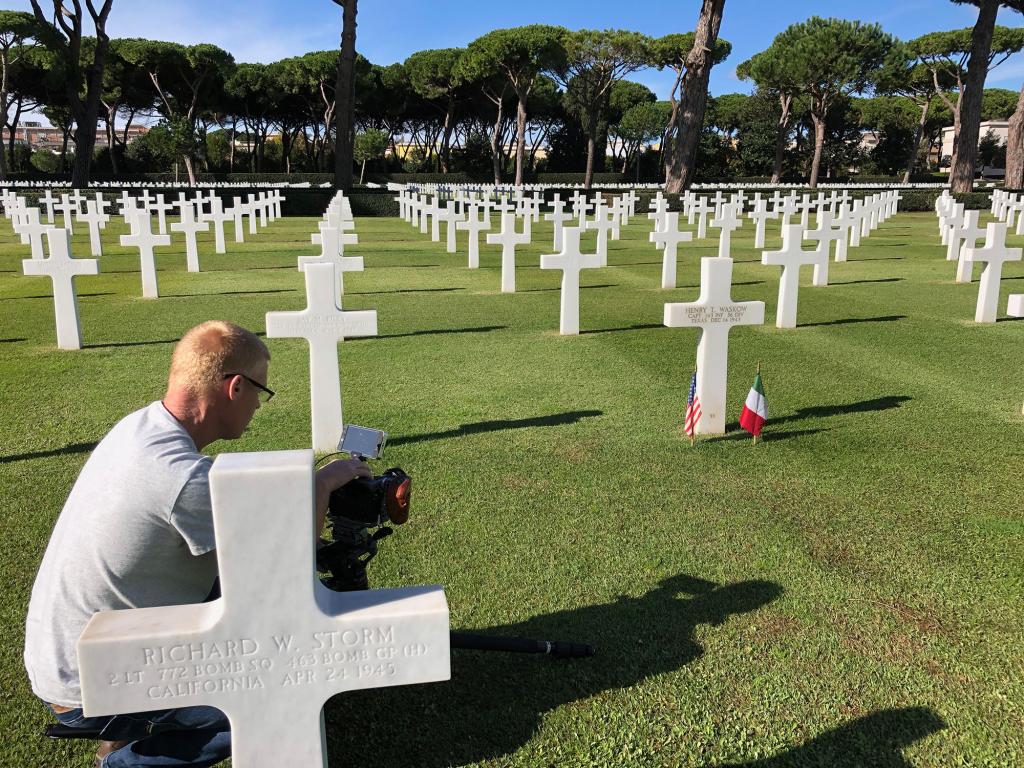 A cameraman in a cemetery