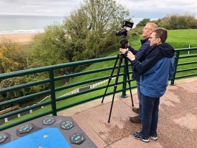Todd Gould and his cameraman shoot images at the beaches of Normandy, France.