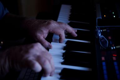 Hands on a piano keyboard