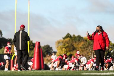 Lynnea Phillips recording an IU football practice on her phone.