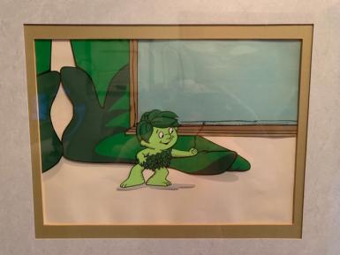 An illustraiton of a small green elf next to a giant's feet