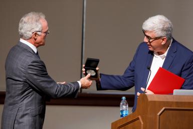 Shanahan, right, presents Scott Pelley, correspondent for "60 Minutes," with an IU Bicentennial Medal after Pelley delivered the keynote address at the Arnolt Center launch in 2019. 