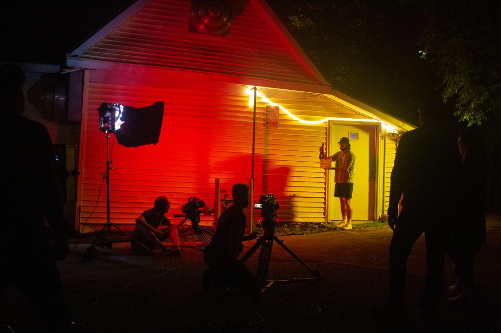 A film shoot outside of a bar at night