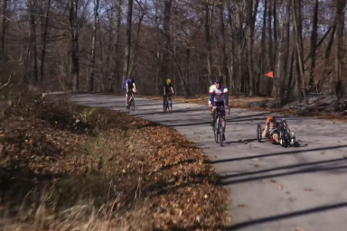 Four cyclists are pictured riding through a curve in Griffy. Tom Morris hand cycles.