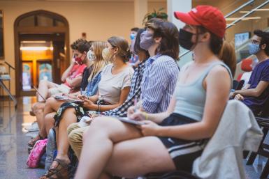 A crowd of students sit in the Franklin Hall commons.