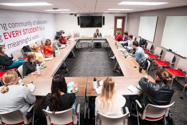 Students sit at a roundtable.
