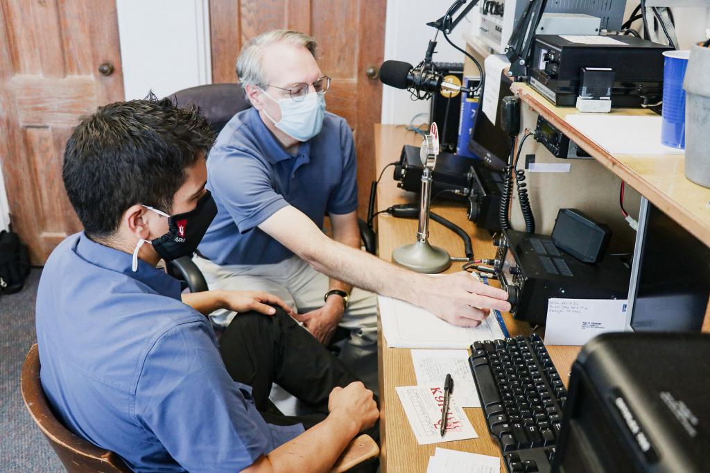 Matt Pierce and Jayson Deese operate amateur radio equipment.