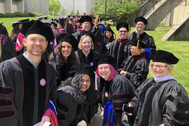 Media School doctoral students and faculty advisors pose on Graduation Day.