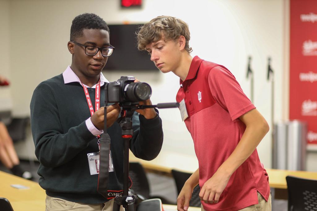Two students look at a camera