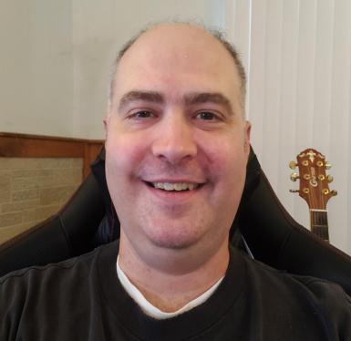 Kevin Miller headshot. White man wearing a black shirt.