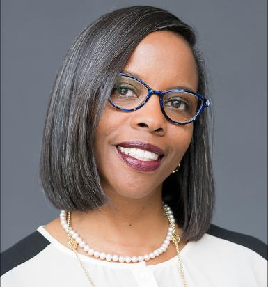 Lisa Lenoir headshot. Black woman wearing glasses and a black-and-white blouse. 