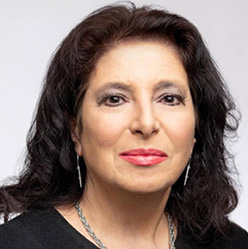 Brunette woman wearing black blouse smiles 