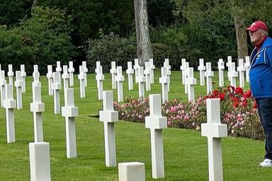 A man stands in the American cemetery in Normandy.