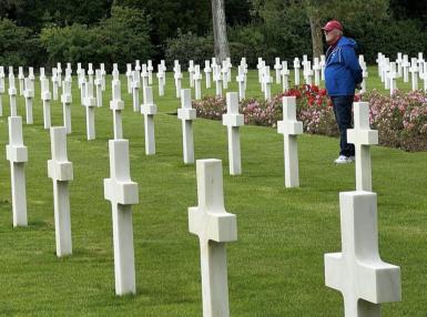 A man stands in the American cemetery in Normandy.