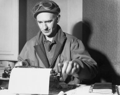 Ernie Pyle types on a typewriter