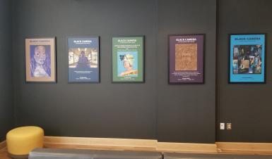 Five previous cover jackets of Black Camera: An International Film Journal are displayed on a gray wall.