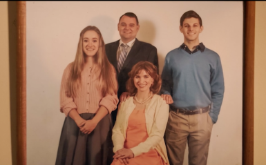 Screenshot from "The Pattersons" film trailer. A family of four poses for a photo