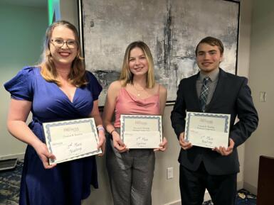 Three student journalists pose with Keating award selection certificates. IU junior Nadia Scharf, who placed third, stands in the middle. 