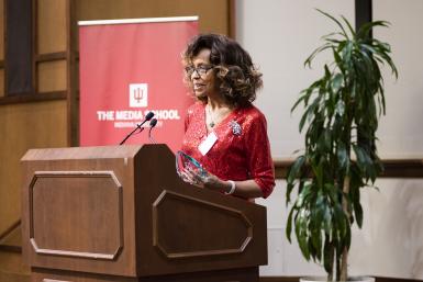 Renee Ferguson speaks at a podium during the DAA ceremony.