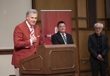 Mike Hayes speaks at a podium during the DAA ceremony.