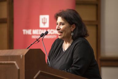 Marcia Parker speaks at a podium during the DAA ceremony.