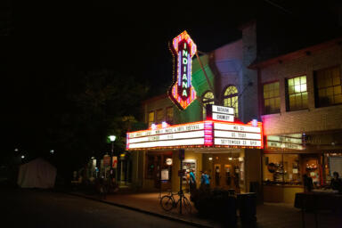 The Buskirk Chumley Theatre is lit up in the night.