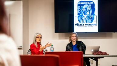 Filmmaker Stephanie Rothman sits in front of a class next to professor Joan Hawkins