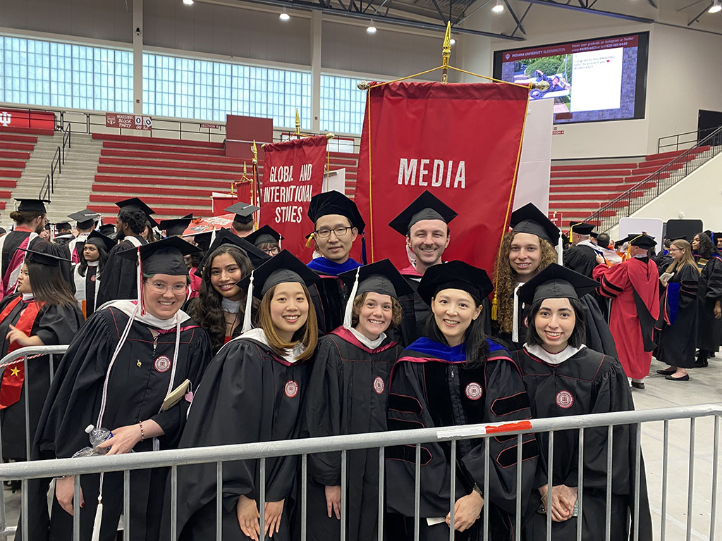 Graduates pose together for a photo.