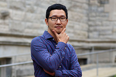 Seung Woo Chae poses for a photo, holding his hand up to his chin.