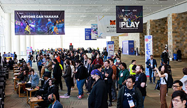 An indoor image of a crowd at the Game Developers Conference. 