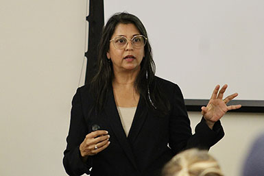 Sonia Shah speaks and gestures with her hands. 