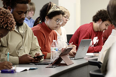 Students sit at desks during Sonia Shah's lecture.