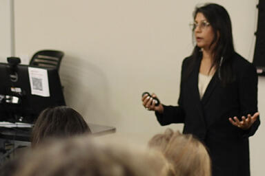 Sonia Shah stands in front of multiple students while teaching.