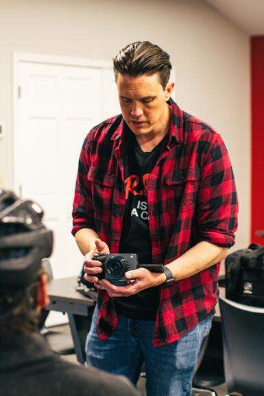 A person shoots film on a camera