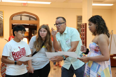 Jay Kincaid giving three students directions