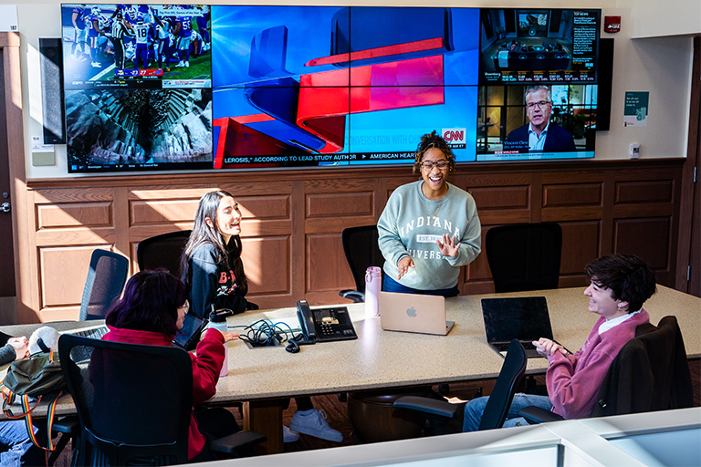 Students talking around a table in the Arnolt Center